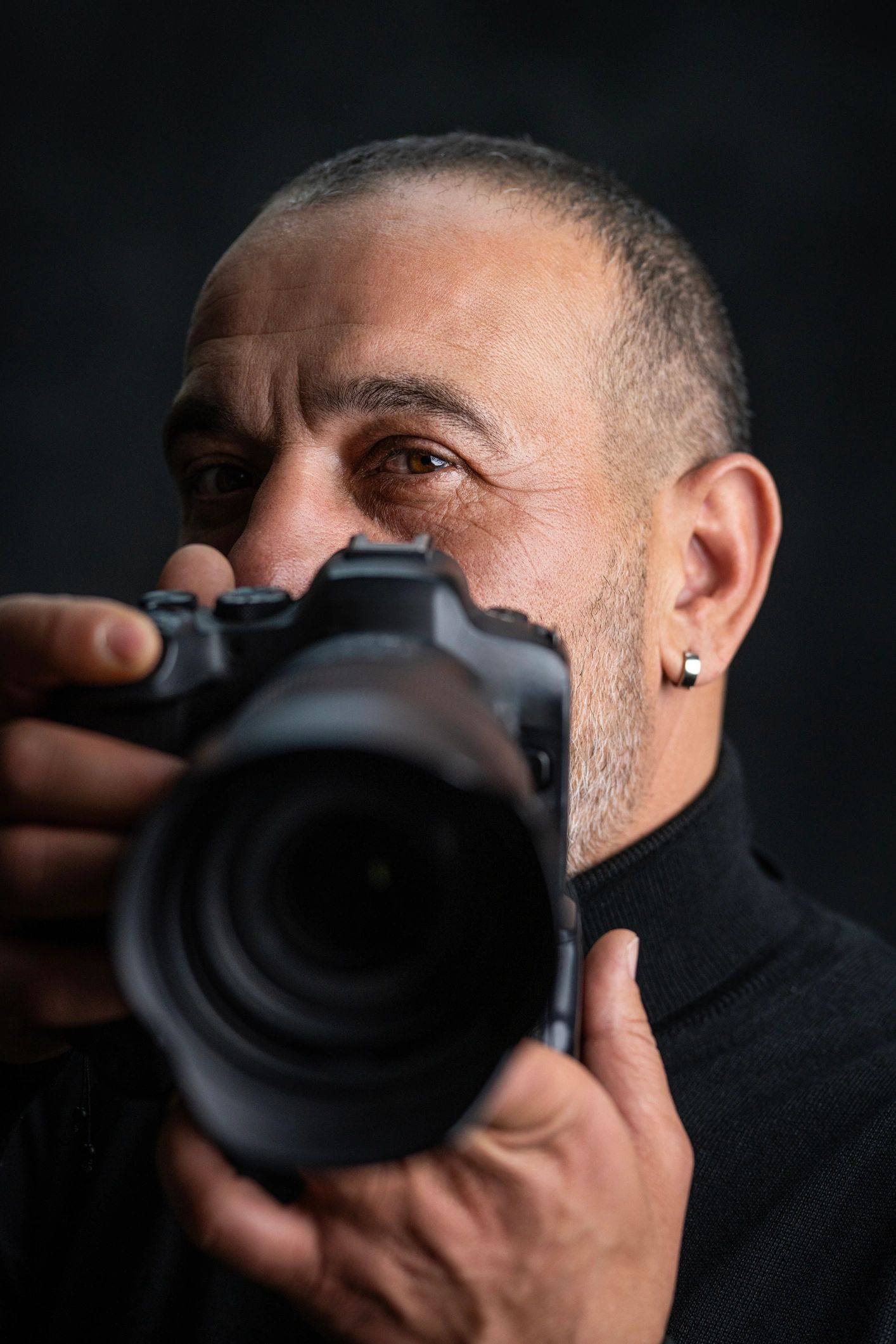 Photographer holding camera in studio close up